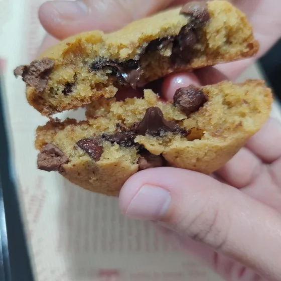 Chocolate chip cookie split open with melted chocolate