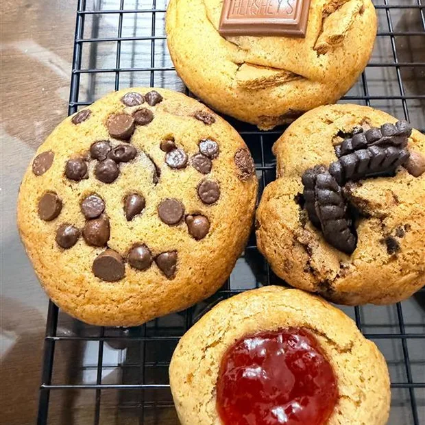Assorted freshly baked cookies on a cooling rack